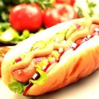 Hot dog, a roll stuffed with sausage, mustard, vegetables, sauces: