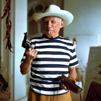 Pablo Picasso holding a revolver given to him by Gary Cooper - Cannes, 1958.